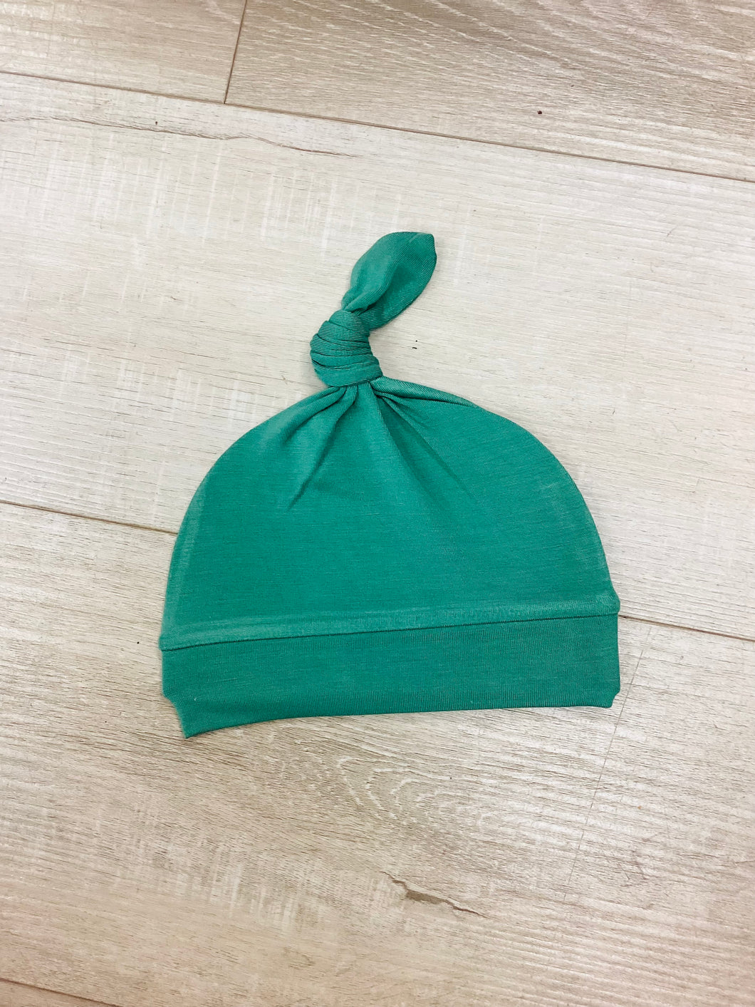 Green top knot hat