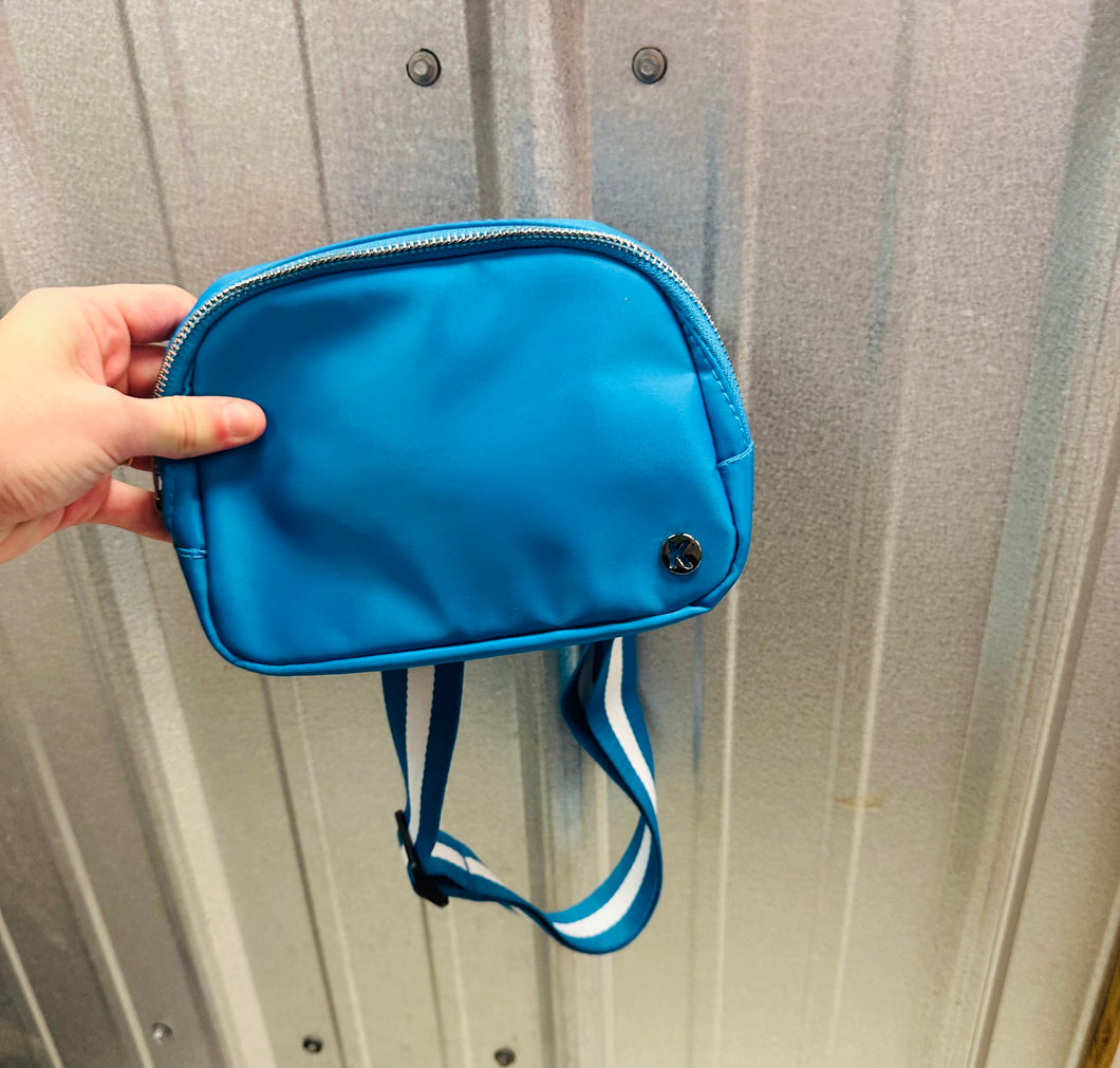 Blue fanny pack with striped strap